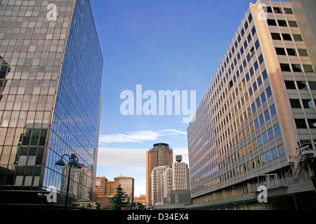 Perspective and underside angle view to textured background of modern glass building skyscrapers over blue sky Stock Photo