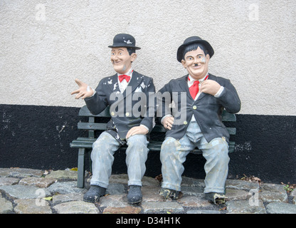 funny Laurel and hardy on a bench in garden Stock Photo