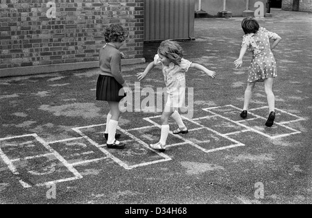 Primary school playground. Girls playing hopscotch. South London. 1970s Britain.England Uk  70s UK HOMER SYKES Stock Photo