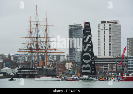 Alex Thomson skipper of Hugo Boss navigates past Portsmouth landmarks en-route to Haslar Marina Stock Photo