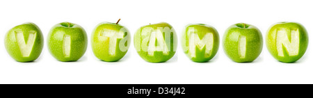 Word 'vitamin' made of green apples on white background. Part of the set. Stock Photo