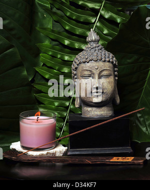 Items for a day spa with a Buddha statue and incense Stock Photo