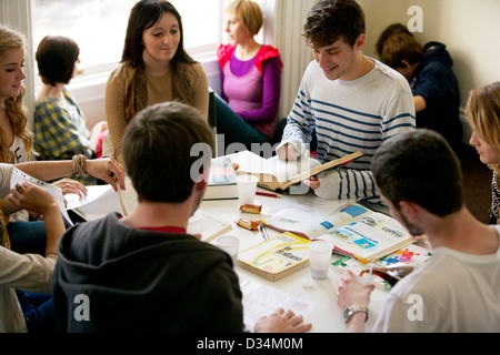 Teenage male and female students studying in a common room Stock Photo