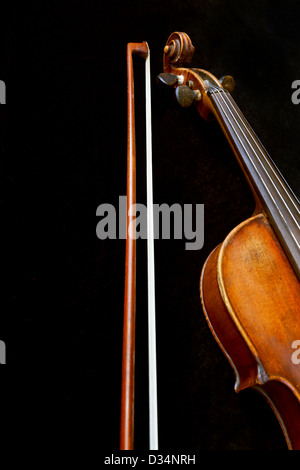 violin neck and bow on black background close up Stock Photo