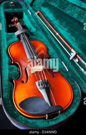 fiddle with bow in green velvet box close up Stock Photo