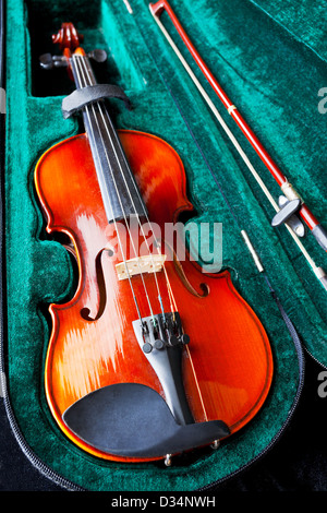 fiddle with bow in green velvet case close up Stock Photo