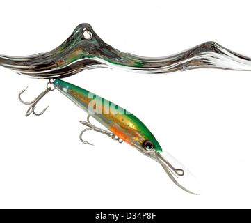 green and orange lure or fishing bait making a splash in water on white background Stock Photo
