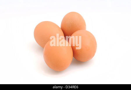 Four organic brown eggs on white background Stock Photo