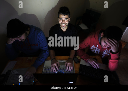 Three young men using laptop computers Stock Photo