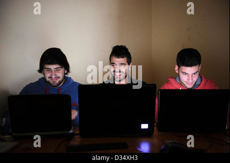 Three young men using laptop computers Stock Photo