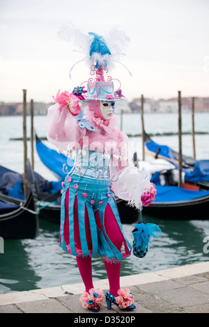 Traditional Venetian masks being worn at the carnival of Venice in San marco square Venice Stock Photo