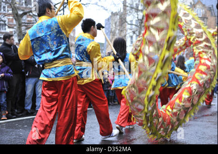 London 10th February 2013. Performers parade through central London and Chinatown to celebrate the Chinesee New Year. This is the year of the snake.  Thousands of people lined the streets to see the colourful parade, despite the cold wet weather. Stock Photo