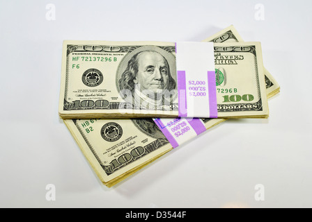 Two stacks of 100 dollar bills isolated over white. Stock Photo