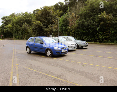 Almost empty little used car park, with only a few cars parked in it Stock Photo