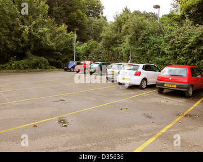 Almost empty little used car park, with only a few cars parked in it Stock Photo