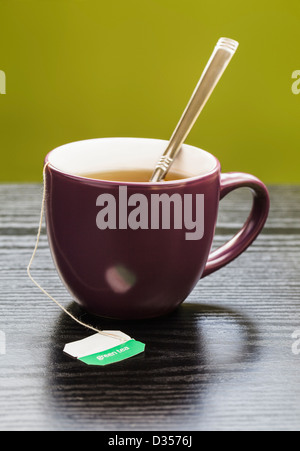 Cup of herbal tea in purple mug Stock Photo