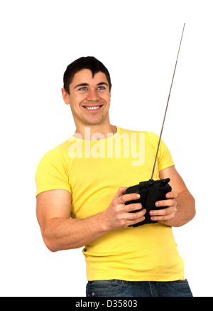 Young athletic man holding a radio remote control (controlling handset) for helicopter or plane.Isolated on white background Stock Photo