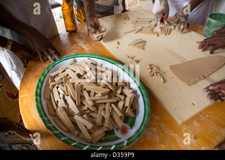 Barsalogho, Burkina Faso, May 2012: Making bisuits from boabab fruit pulp for sale. Stock Photo