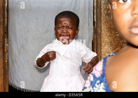Baby African black girl crying with sister in front Stock Photo