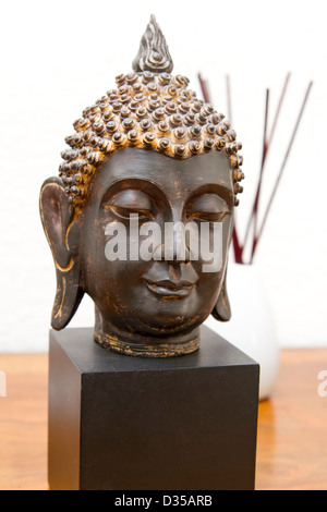 Buddha head and incense sticks Stock Photo