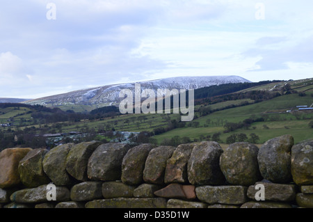 Pendle Hill from the top of Pasture Lane Between Barrowford and Roughlee in winter with a Dry Stone Wall in the foreground. Stock Photo