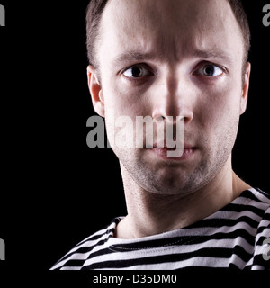 Young Caucasian sailor man's portrait. Close-up photo in the dark Stock Photo