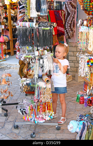 Little girl buys in a street store Stock Photo