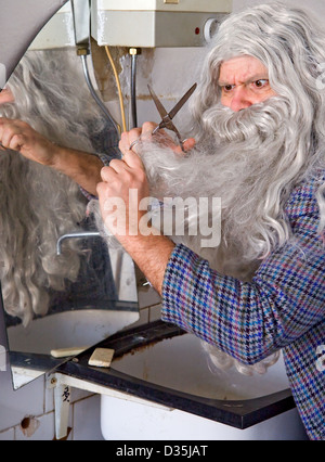 man cuts his beard Stock Photo
