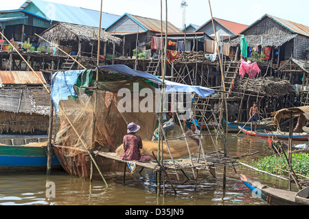 Local women mend fish nets in Kompong Pluk, a group of three stilt house villages near Siem Reap, Cambodia Stock Photo