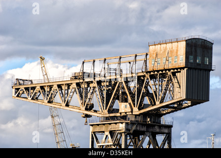 A very large crane, a local landmark, reflects the glow of the evening sunlight. Stock Photo