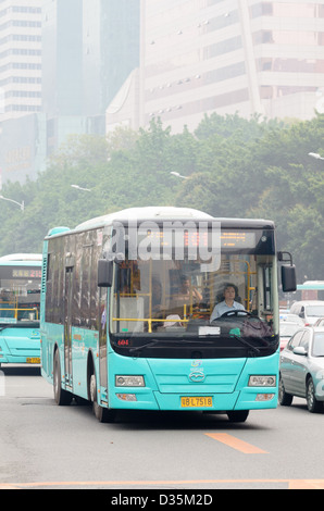 Modern Chinese bus, in service in a major city in China. Urban public transport; heavy traffic; bus service; buses; slow traffic; transportation Stock Photo