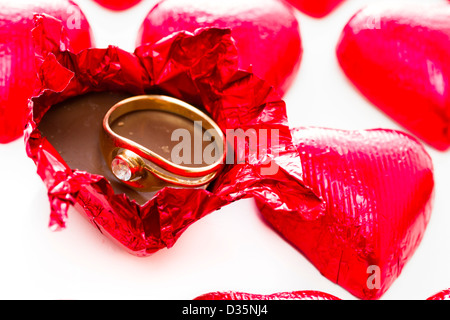 Golden ring with diamond on top of the chocolate candy. Stock Photo