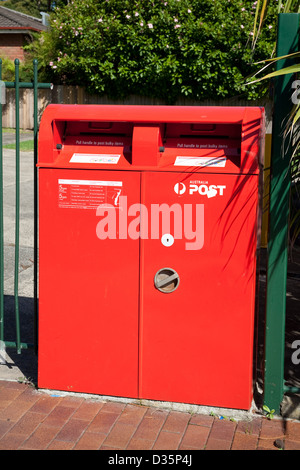 Australia Post red post box set on brick pavers Stock Photo