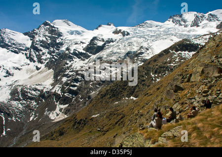 Hikers watching landscape on Gran Paradiso mountain, Gran Paradiso National Park, Graian Alps - Italy Stock Photo