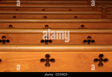 Row of wooden pews receding in church Stock Photo