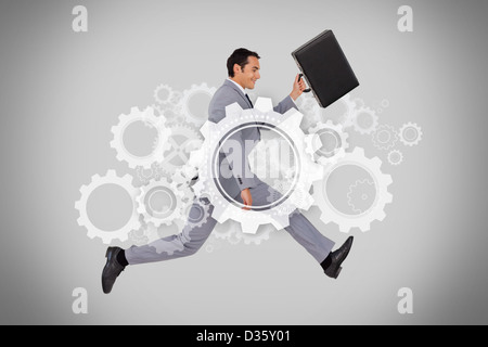 Businessman running with briefcase on grey background Stock Photo