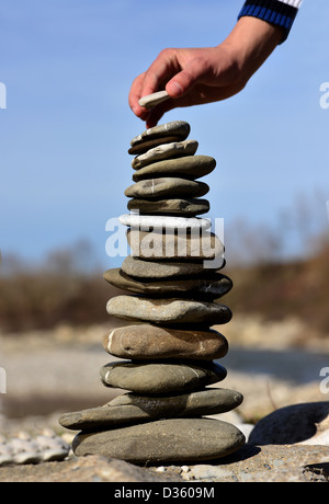 Balanced Stones. Stack of volcanic pebbles on seashore Stock Photo