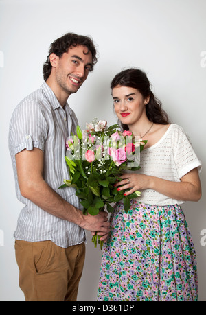 Couple holding bunch of flowers Stock Photo