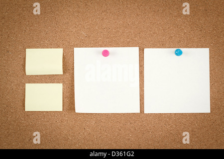 four empty note papers on cork board Stock Photo
