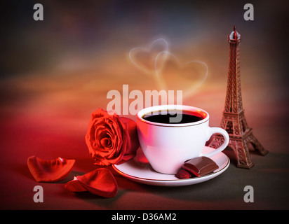 Picture of white cup with morning tea in Valentine day, grunge background, red rose, chocolate candy, decorative Eiffel tower Stock Photo
