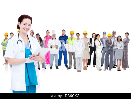 Pretty doctor standing in front of diverse career group Stock Photo