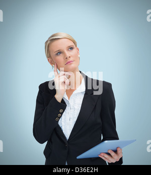 Thoughtful businesswoman with tablet pc Stock Photo