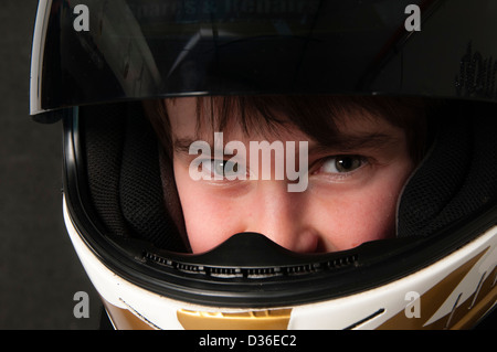 Child Wearing A Motorsport Crash Helmet Stock Photo