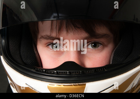 Child Wearing A Motorsport Crash Helmet Stock Photo