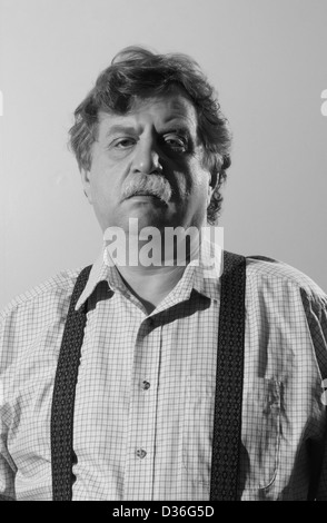 middle-aged man in a light shirt and suspenders, black and white  Stock Photo