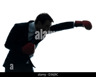 one  businessman with boxing gloves in silhouette studio isolated on white background Stock Photo