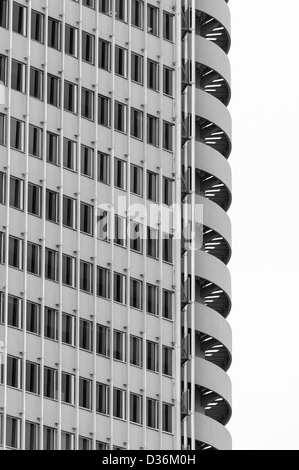 Office building facade with external spiral stair. Stock Photo