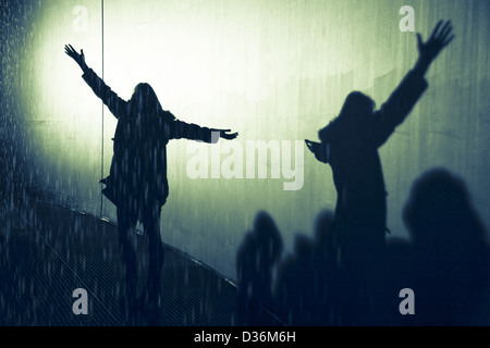 shadow of silhouette woman in the rain with arms open and outstretched ...