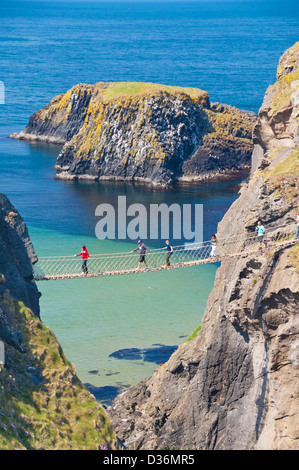 Tourists crossing the Carrick a rede rope bridge to Carrick island Ballycastle County Antrim Northern Ireland UK GB EU Europe Stock Photo