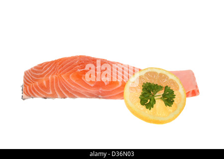 Salmon steak and a slice of lemon with parsley isolated against white Stock Photo